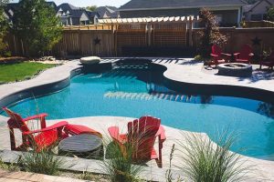 LR Moving and Delivery safely transporting a covered hot tub on a flatbed trailer during a winter move at a residential property in Ontario.